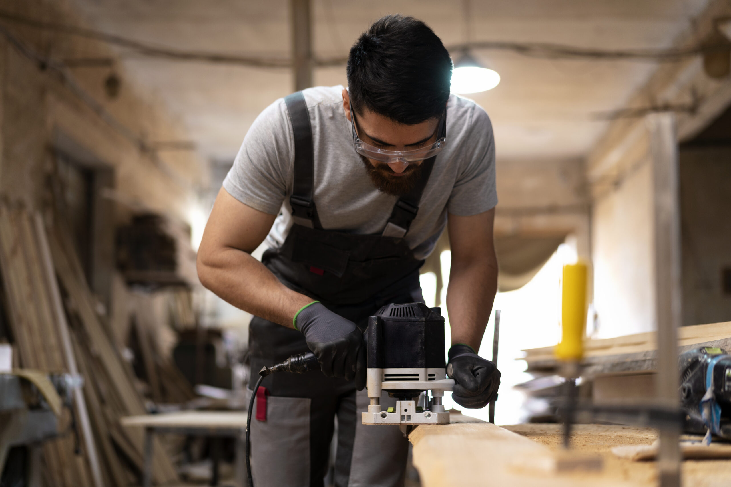 carpenter-cutting-mdf-board-inside-workshop